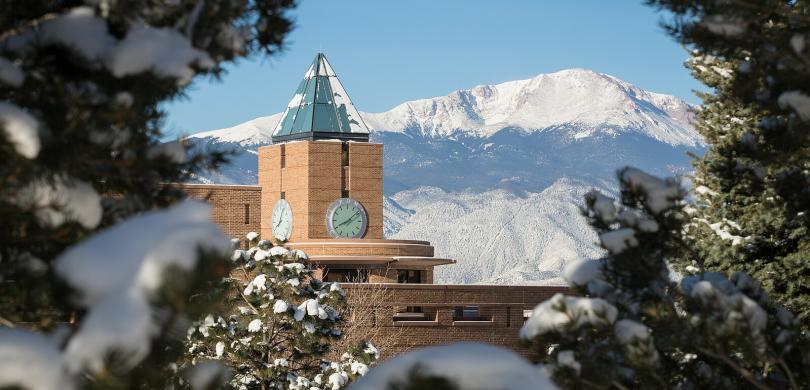 University of Colorado in Colorado Springs (UCCS) building with snow-capped mountains in background